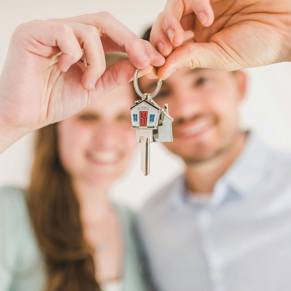 Happy Couple Holding and Showing a House Key